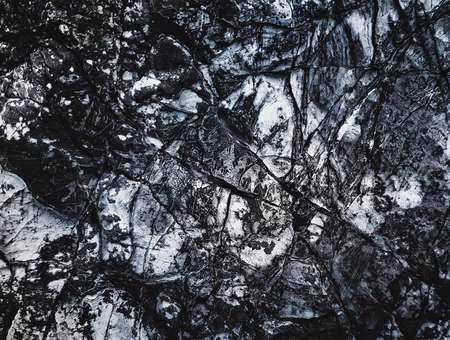 Black texture. Stone background. Dark marble. Rock texture. Rock surface with cracks. Rock pile. Paint spots wall. Grunge Rough structure. Abstract texture.の写真素材