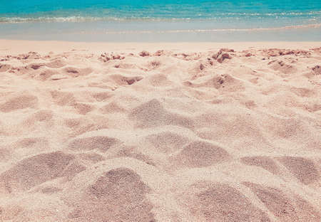 Background beach with sea wave, Es Trenc, Mallorca. Relax atmosphere. Texture sand. Gentle pastel colors. Vintage filter. Blue sky and azure coast.の写真素材