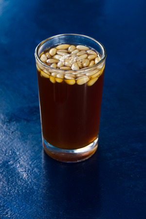 Hot cup of herbal tea  on blue table