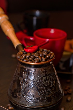 Turk coffee with coffee beans and red spoonの写真素材