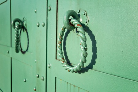 Green wrought iron round handles on doors