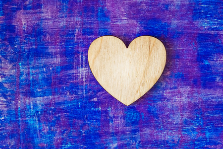 Wooden heart on abstract lilac painted wooden wall witn strokesの写真素材