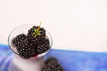 Fresh blueberries in glass cup soft focus