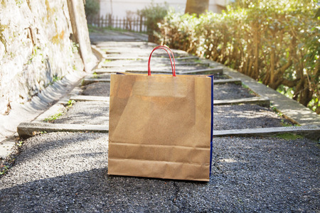 brown paper bag is on the road to a shop in the city of Italy