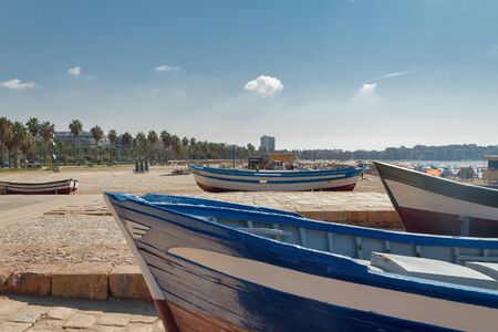 wooden old blue and white boats on the Mediterranean coast in Spain, Salou beachの写真素材
