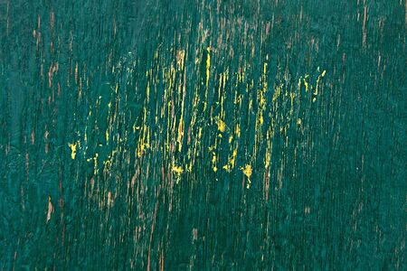 wooden texture green with yellow spot fence with cracked paintの写真素材