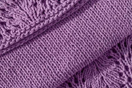 knitting openwork needles violet-colored dress with lace coquette on right on lilac background diagonallyの写真素材