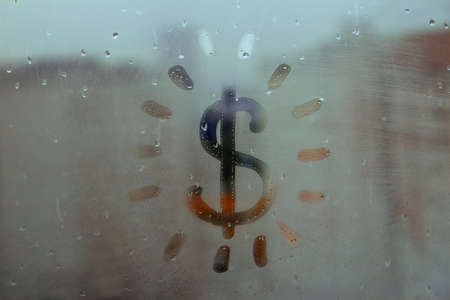 Hand drawn shape dollar icon with rays like sun for text on muddy glass wet blue window in city