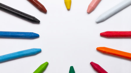 multicolored pastel crayons lie in the shape of a circle on a white background, copy space, bannerの写真素材