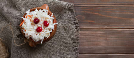 sauerkraut with cranberries on wooden table on sackcloth, 16:10の写真素材