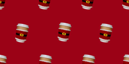 seamless pattern paper beige cups with white lid dressed in santa claus clothes on red backgroundの写真素材