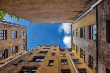 blue sky and well from houses blue sky and well from houses in yard-well, st. Petersburg, Russia, Europe, bottom view, perspectiveの写真素材