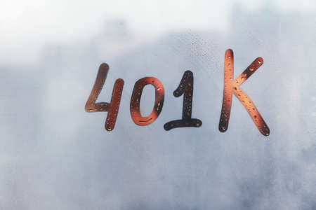 Hand drawn numbers 401K on foggy glass on suset windowの写真素材