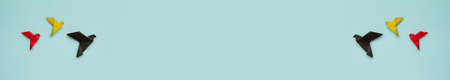 banner two groups three paper origami pigeons black, yellow, red on light blue background