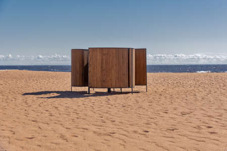 wooden natural beach cabana for changing clothes by sea on sunny dayの写真素材