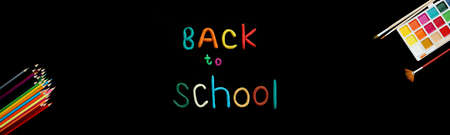 banner words of multi-colored plasticine back to school in middle and watercolor paints, brushes and...