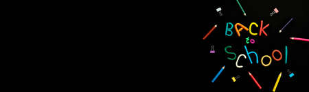 banner words of multi-colored plasticine back to school and pens, paper clips, on black background top viewの写真素材