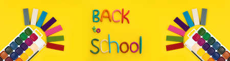 banner handmade words of multi-colored plasticine back to school watercolor paints and multi-colored plasticine on yellow background, copy spaceの写真素材