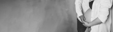 banner black and white unrecognizable people pregnant body of woman and man in casual support mom's...