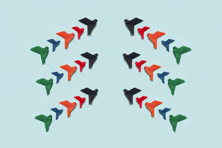 banner three groups of ten paper origami pigeons black, red, orange, blue and green fly up facing...