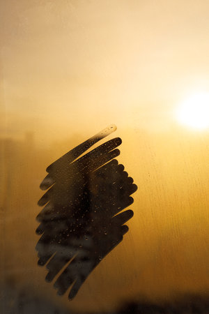 Hand drawn shape for text on muddy glass wet window in yellow color