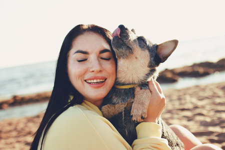 Happy real woman holding pet dog sheepdog puppy