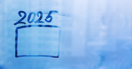 Doodle numbers 2025 of new year and frame on foggy glass window on blue backgroundの写真素材