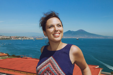 Young brunette woman smiles, enjoying the breathtaking viewの写真素材