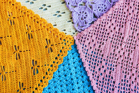 Lots of colorful hand-made crocheted scarves and kerchiefs with different patterns