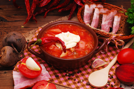 The traditional national Ukrainian beet soup borscht on the old wooden backgroundの写真素材