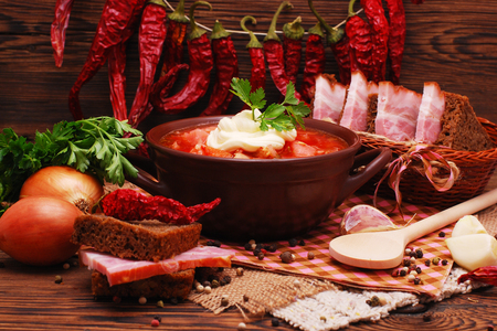 The traditional national Ukrainian beet soup borscht on the old wooden backgroundの写真素材