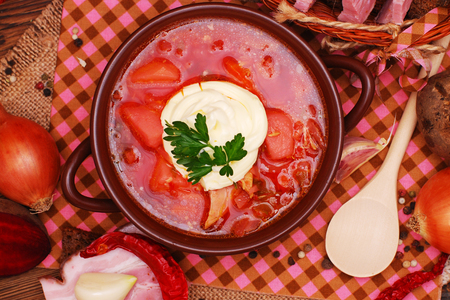 The traditional national Ukrainian beet soup borscht on the old wooden backgroundの写真素材
