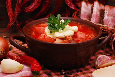 The traditional national Ukrainian beet soup borscht on the old wooden backgroundの写真素材
