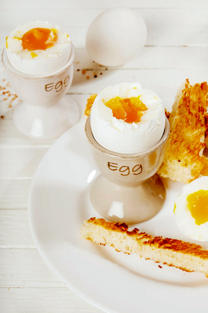 Breakfast with eggs and coffee on a white background.の写真素材