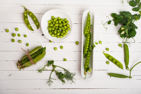 Fresh organic green peas on a wooden background. Rustic style.の写真素材