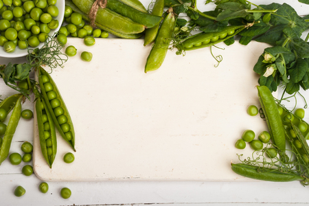 Fresh organic green peas on a wooden background. Rustic style.の写真素材