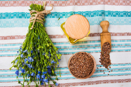 Linseed oil, flax seeds, and flowers on a light background.の写真素材