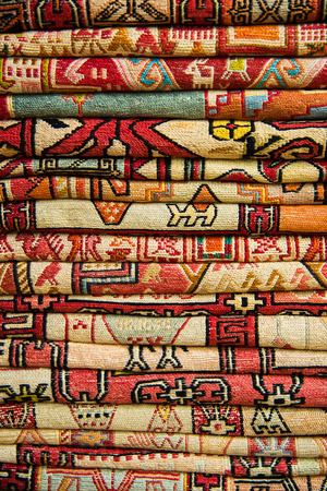 Bright, colorful Turkish fabrics, bedspreads and kerchiefs with different oriental patterns. The texture of the textile or fabric, macro. Tissue, textile, cloth, material, woven.の写真素材