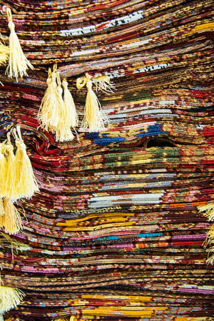 Bright, colorful Turkish fabrics, bedspreads and kerchiefs with different oriental patterns. The texture of the textile or fabric, macro. Tissue, textile, cloth, material, woven.の写真素材