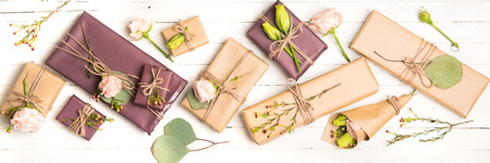 Flowers composition. Flowers and gifts on white background. Flat lay, top view.の写真素材