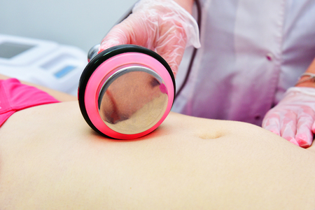 Rf skin tightening, belly. Hardware cosmetology. Body care. Non surgical body sculpting. Ultrasound cavitation body contouring treatment, anti-cellulite and anti-fat therapy in beauty salon.の写真素材