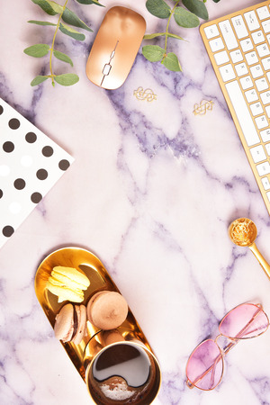 Flat lay. View from above. Business concept with a golden computer keyboard, macarons, a cup of coffee. Place for text.の写真素材