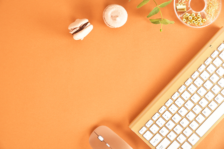 Flat lay. View from above. Business concept with a golden computer keyboard, macarons, a cup of coffee. Place for text.の写真素材