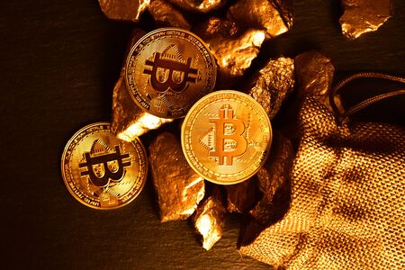 Concept of bitcoin coins and gold stones. Close-up.の写真素材