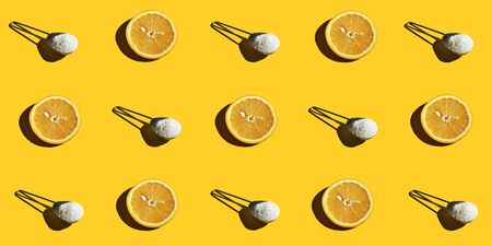 Collagen with orange juice, vitamin C on a yellow background. Pattern. Superfood, healthy food in the early morning.の写真素材
