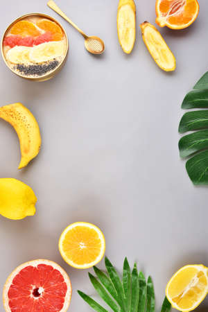 Concept on a gray background. Tropical fruits. Frame.