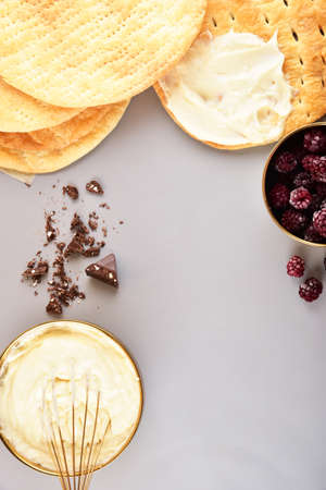 Baking concept on gray background. Cream and cake layers. Space for text.の写真素材