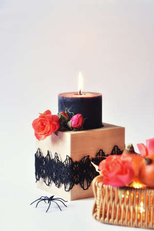 Autumn still life with a candle on a light gray background. Aesthetics