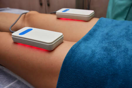 lipo laser. Hardware cosmetology. Body care. Non surgical body sculpting. body contouring treatment, anti-cellulite and anti-fat therapy in beauty salonの写真素材