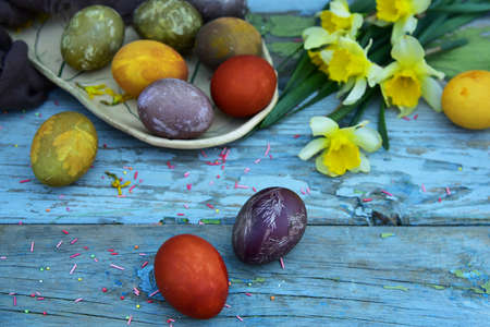 Multicolored Easter eggs on vintage background. View from above. Flat lay.の写真素材